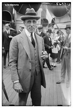 A person in a suit and hat

AI-generated content may be incorrect.